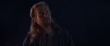 Movie still from “DragonHeart” (1996), directed by Rob Cohen – A person with long blonde hair; Close Up shot, Low angle