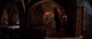 Movie still from “DragonHeart” (1996), directed by Rob Cohen – Two women are standing in a room with candles; Wide shot, High angle