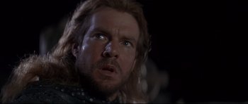 Movie still from “DragonHeart” (1996), directed by Rob Cohen – A person with long brown hair; Close Up shot, Low angle