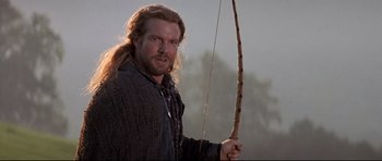 Movie still from “DragonHeart” (1996), directed by Rob Cohen – A person holding a bow and arrow; Close Up shot, Low angle