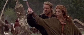 Movie still from “DragonHeart” (1996), directed by Rob Cohen – A man and a woman holding a sword in a forest; Medium shot, Low angle