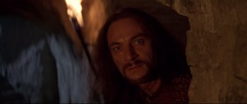 Movie still from “DragonHeart” (1996), directed by Rob Cohen – A person with long black hair; Close Up shot, Low angle