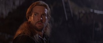 Movie still from “DragonHeart” (1996), directed by Rob Cohen – A person with long hair and a beard; Close Up shot, Over the shoulder angle