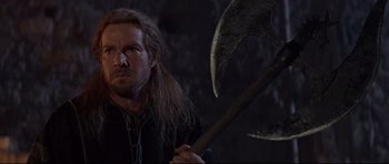 Movie still from “DragonHeart” (1996), directed by Rob Cohen – A person holding an axe; Close Up shot, Low angle