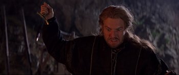 Movie still from “DragonHeart” (1996), directed by Rob Cohen – A person with long hair and a beard; Close Up shot, Low angle