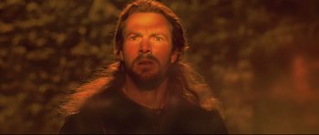 Movie still from “DragonHeart” (1996), directed by Rob Cohen – A man with long hair and a goatee stares ahead; Close Up shot, Low angle