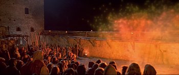 Movie still from “DragonHeart” (1996), directed by Rob Cohen – A crowd of people watching a fire show; Extreme Wide shot, High angle