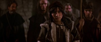 Movie still from “Dragonslayer” (1981), directed by Matthew Robbins – A woman wearing a hat and a fur coat; Close Up shot, Over the shoulder angle