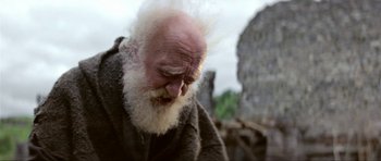 Movie still from “Dragonslayer” (1981), directed by Matthew Robbins – An old man with a beard and a white beard; Close Up shot, Low angle