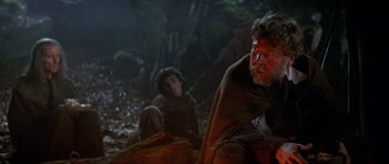 Movie still from “Dragonslayer” (1981), directed by Matthew Robbins – Two people sitting in the woods in the dark; Medium shot, Over the shoulder angle