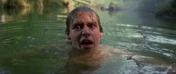 Movie still from “Dragonslayer” (1981), directed by Matthew Robbins – A man in a body of water with his head in the water; Close Up shot, Low angle
