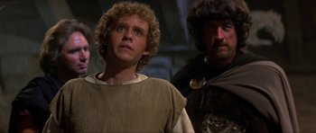 Movie still from “Dragonslayer” (1981), directed by Matthew Robbins – Two men in medieval garb standing next to each other; Close Up shot, Low angle