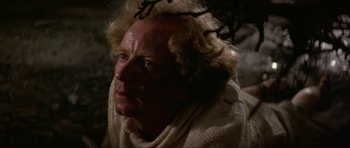 Movie still from “Dragonslayer” (1981), directed by Matthew Robbins – An old man with a strange look on his face; Close Up shot, High angle