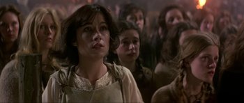 Movie still from “Dragonslayer” (1981), directed by Matthew Robbins – A group of people standing in front of a crowd; Close Up shot, Low angle