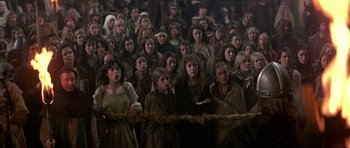 Movie still from “Dragonslayer” (1981), directed by Matthew Robbins – A group of people in a crowd of people; Wide shot, High angle