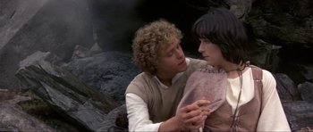 Movie still from “Dragonslayer” (1981), directed by Matthew Robbins – A man and a woman holding each other while standing next to each other; Close Up shot, High angle