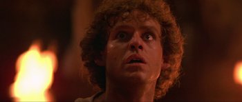 Movie still from “Dragonslayer” (1981), directed by Matthew Robbins – A person with curly hair looking up; Close Up shot, Low angle