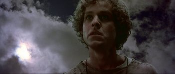 Movie still from “Dragonslayer” (1981), directed by Matthew Robbins – A person with curly white hair; Close Up shot, Low angle