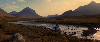 Movie still from “Dragonslayer” (1981), directed by Matthew Robbins – A person riding a horse near a body of water; Extreme Wide shot, High angle
