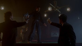 A group of people in a dark room holding guns