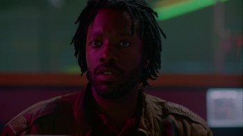 A person with dreadlocks looking at the camera