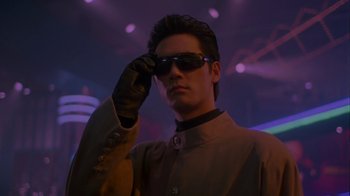 A man wearing a pair of sunglasses and a leather glove