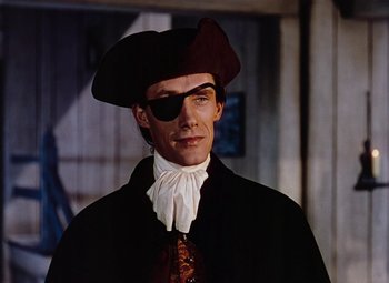 Movie still from “Drums Along the Mohawk” (1939), directed by John Ford – A man wearing a pirate's hat and eye patch; Close Up shot, Over the shoulder angle
