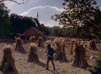 Movie still from “Drums Along the Mohawk” (1939), directed by John Ford – A man standing in the middle of a field; Extreme Wide shot, Low angle