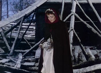 Movie still from “Drums Along the Mohawk” (1939), directed by John Ford – A woman dressed as a vampire holding a bat; Medium shot, Low angle