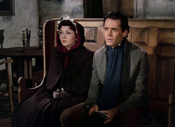 Movie still from “Drums Along the Mohawk” (1939), directed by John Ford – A man and a woman sitting next to each other; Medium shot, High angle