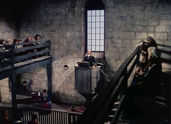 Movie still from “Drums Along the Mohawk” (1939), directed by John Ford – A man standing at the top of a staircase; Extreme Wide shot, High angle