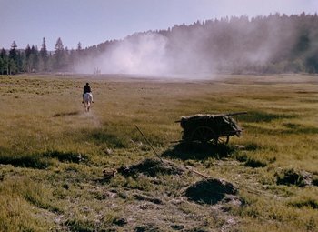 Movie still from “Drums Along the Mohawk” (1939), directed by John Ford – A person riding a horse in the middle of a field; Extreme Wide shot, High angle