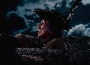 Movie still from “Drums Along the Mohawk” (1939), directed by John Ford – An old man wearing a pirate's hat looking at the sky; Medium shot, Low angle