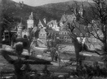 Movie still from “Duck Soup” (1933), directed by Leo McCarey – A black and white photo of a town with many buildings; Extreme Wide shot, High angle