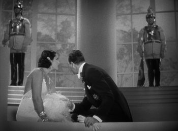 Movie still from “Duck Soup” (1933), directed by Leo McCarey – A man and a woman in formal wear on a stage; Wide shot, High angle