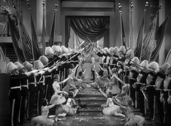 Movie still from “Duck Soup” (1933), directed by Leo McCarey – A black and white photo of a group of people in costumes; Extreme Wide shot, High angle