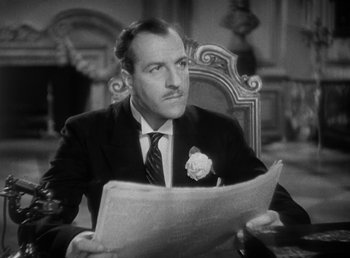 Movie still from “Duck Soup” (1933), directed by Leo McCarey – A black and white photo of a man reading a newspaper; Close Up shot, High angle
