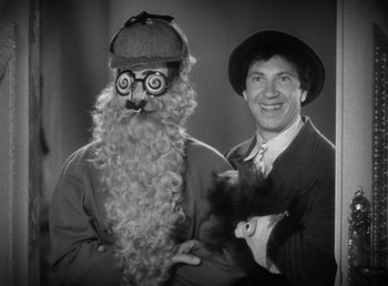 Movie still from “Duck Soup” (1933), directed by Leo McCarey – A man holding a black cat and a man with a fake beard; Close Up shot, High angle