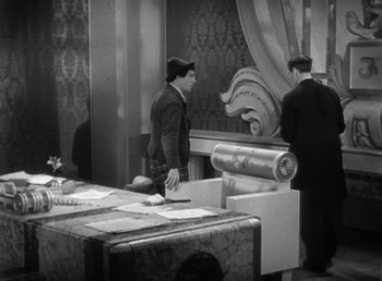 Movie still from “Duck Soup” (1933), directed by Leo McCarey – Two men are standing in front of a table; Medium shot, High angle