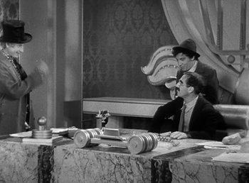 Movie still from “Duck Soup” (1933), directed by Leo McCarey – Two men sitting at a table in front of a mirror; Wide shot, Over the shoulder angle