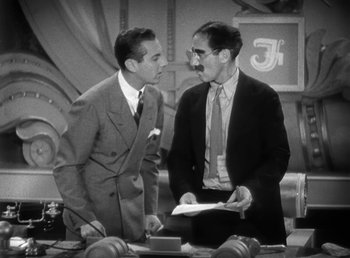 Movie still from “Duck Soup” (1933), directed by Leo McCarey – Two men in suits are talking to each other; Medium shot, Over the shoulder angle