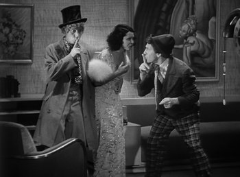 Movie still from “Duck Soup” (1933), directed by Leo McCarey – A group of people standing next to each other in a room; Medium shot, High angle