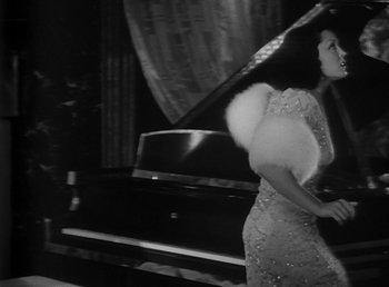 Movie still from “Duck Soup” (1933), directed by Leo McCarey – A black and white photo of a woman in a dress; Medium shot, High angle