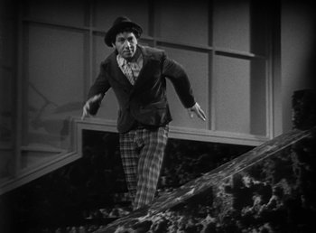 Movie still from “Duck Soup” (1933), directed by Leo McCarey – An old man in a hat is jumping on a skateboard; Wide shot, Low angle