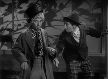 Movie still from “Duck Soup” (1933), directed by Leo McCarey – Two men in hats and jackets are standing together; Medium shot, High angle