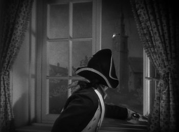 Movie still from “Duck Soup” (1933), directed by Leo McCarey – A man in a pirate costume looking out of a window; Medium shot, Low angle