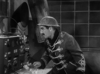 Movie still from “Duck Soup” (1933), directed by Leo McCarey – An old photo of a man in a military uniform; Medium shot, High angle