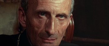 Movie still from “Duck, You Sucker!” (1971), directed by Sergio Leone – An older man with a shaved head looking at the camera; Close Up shot, Low angle