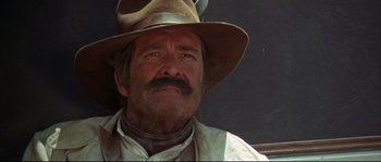 Movie still from “Duck, You Sucker!” (1971), directed by Sergio Leone – An older man wearing a cowboy hat and vest; Close Up shot, Low angle