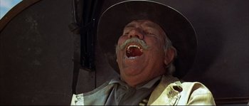 Movie still from “Duck, You Sucker!” (1971), directed by Sergio Leone – An old man with a mustache and a cowboy hat; Close Up shot, Low angle
